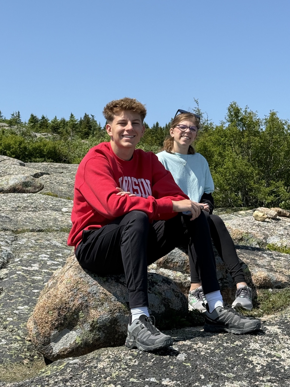 Lauren and Brady sitting together on a hike